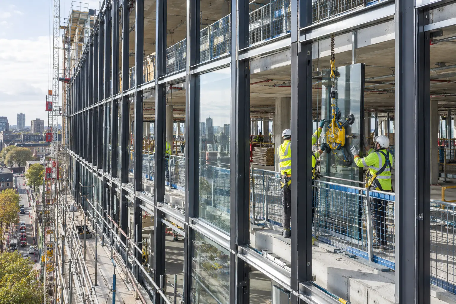 Stick system curtain wall framing installed floor by floor